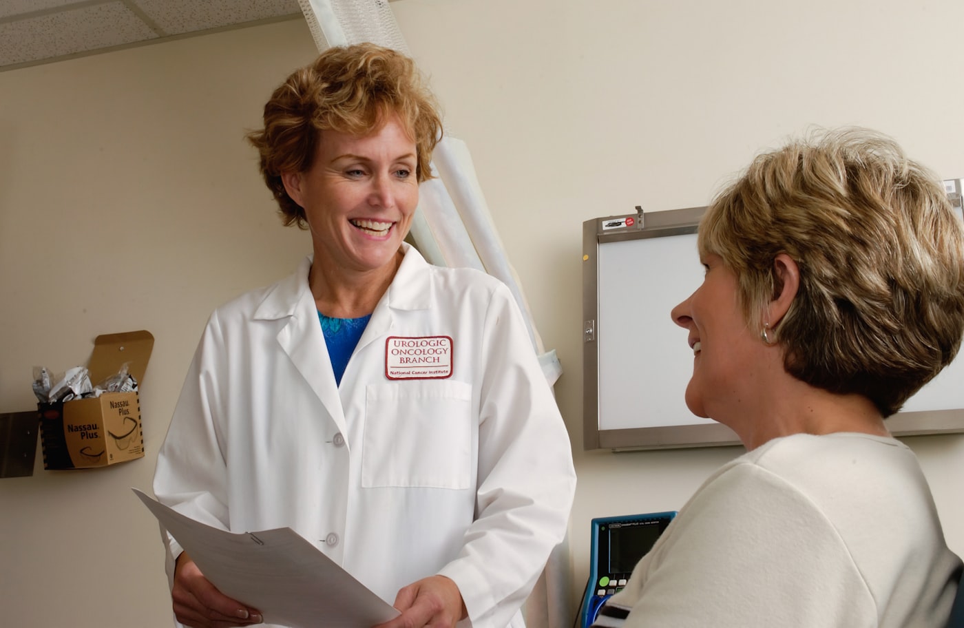 Clinic receptionist booking a new patient appointment at the front desk
