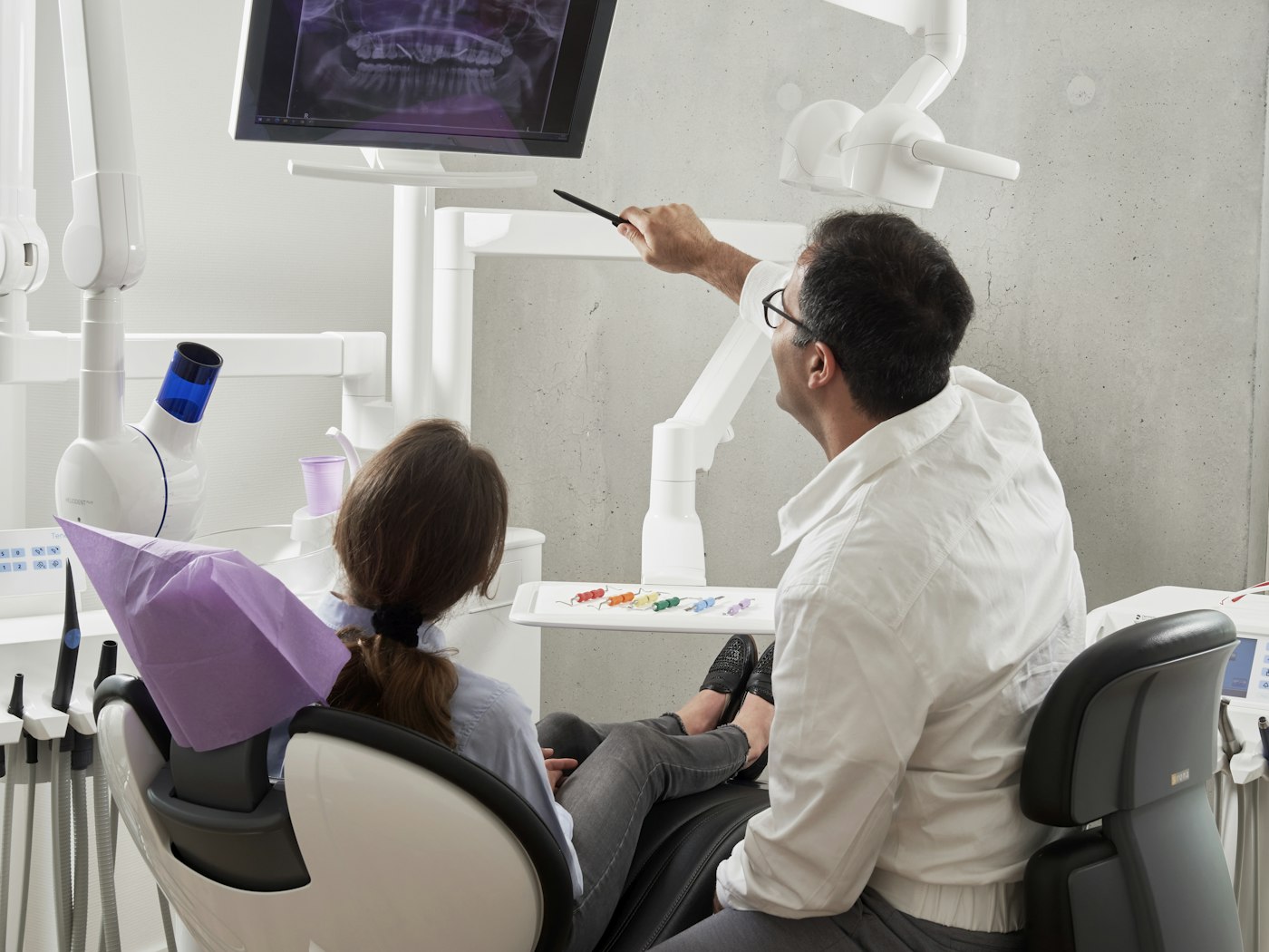 Occupational therapist discussing a referral with a healthcare colleague in an office