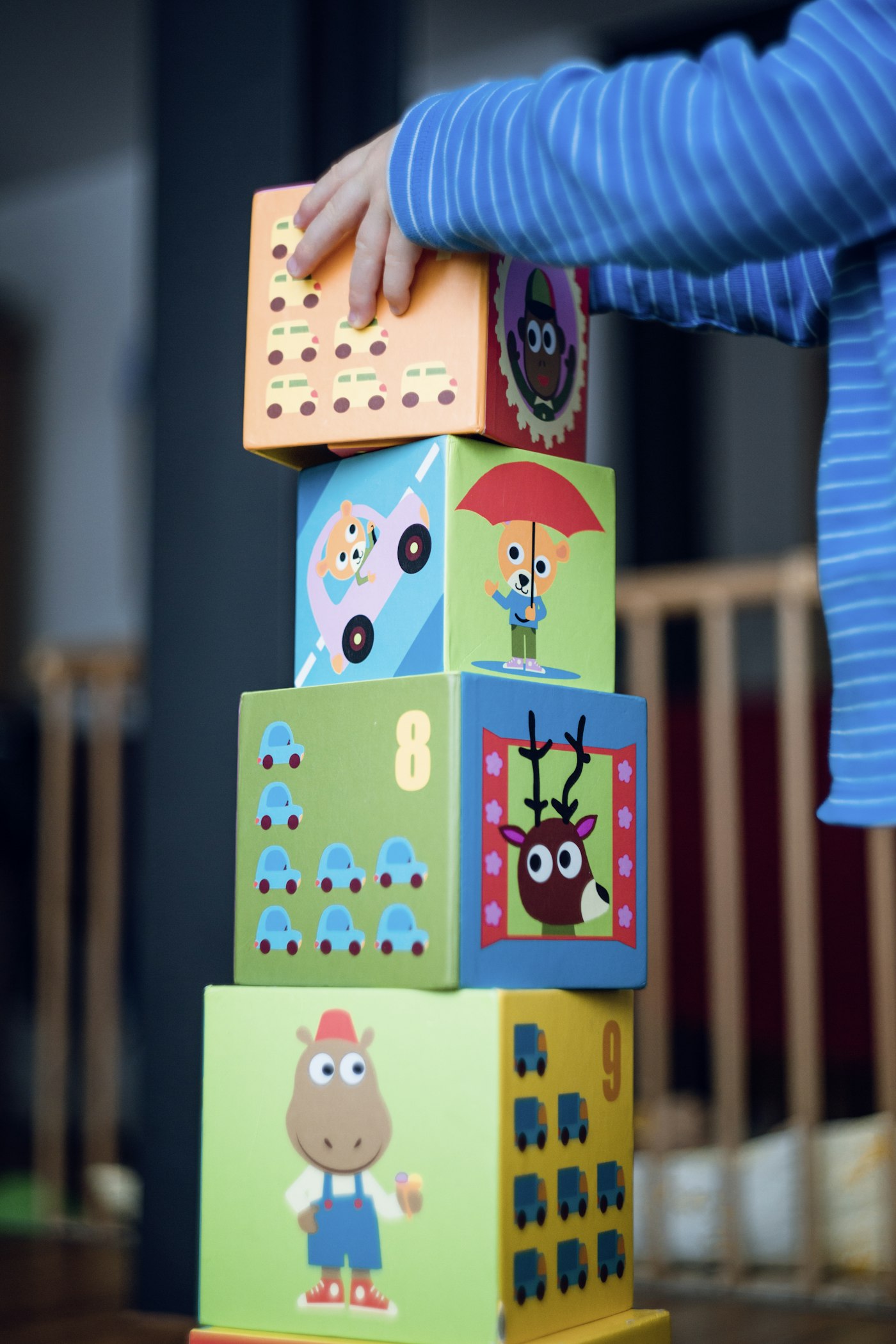 Child practising fine-motor skills by stacking colourful blocks - common paediatric OT imagery